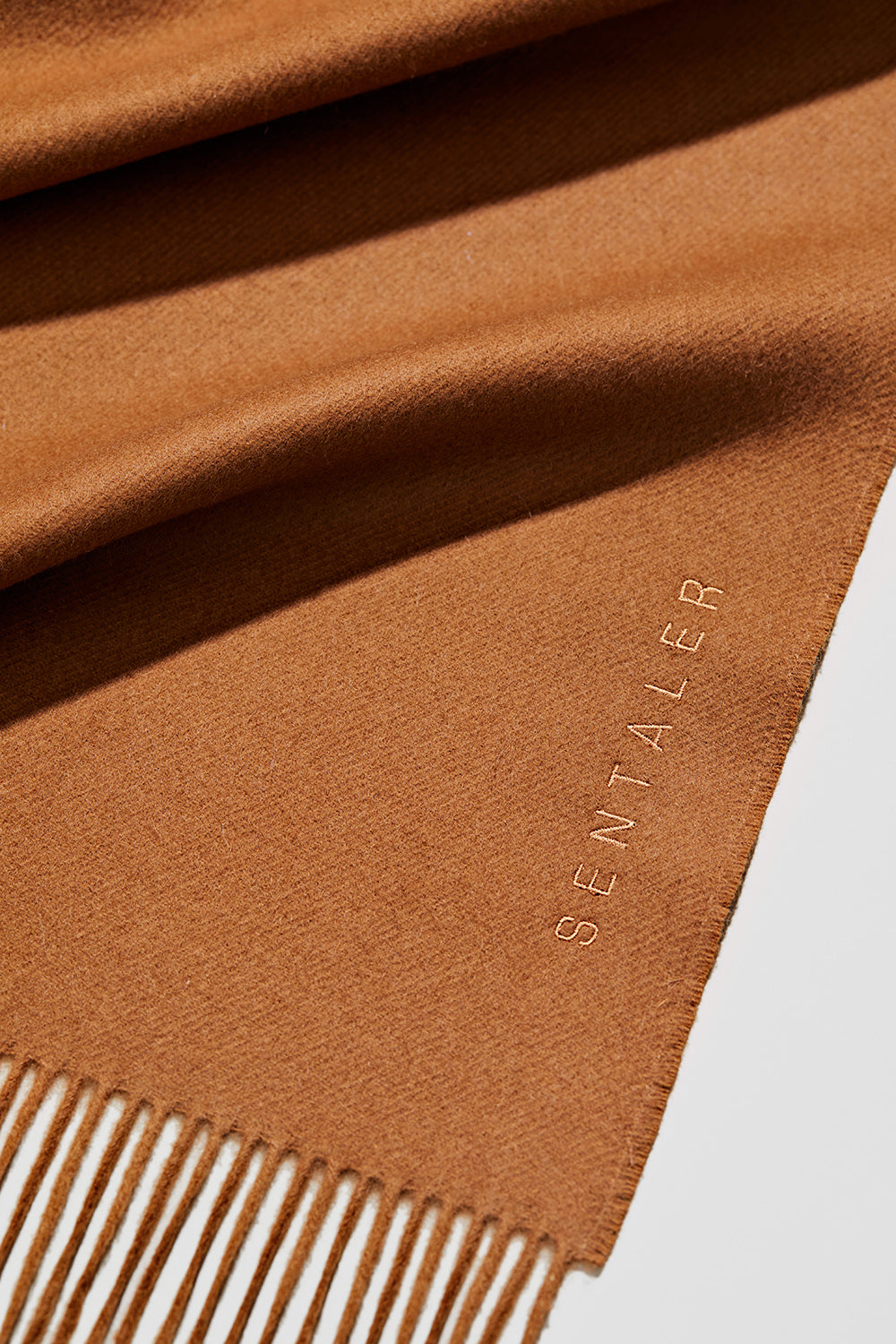 Sentaler SENTALER Vicuña Classic Scarf featured in Vicuña and available in Vicuña. Seen as off figure close up.