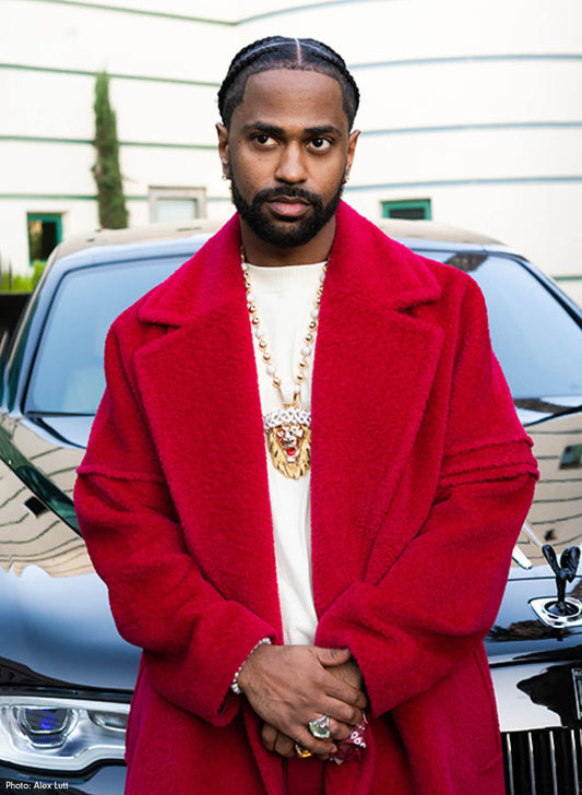 American rapper Big Sean is wearing the SENTALER Men Technical Bouclé Alpaca Robe Coat in Fuchsia and seen from the waist up.