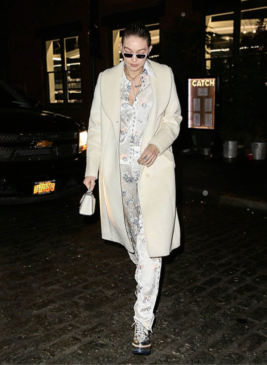 American model and television personality Gigi Hadid is wearing the SENTALER Classic Long Coat with Shawl Collar in Ivory at night in the streets of New York.