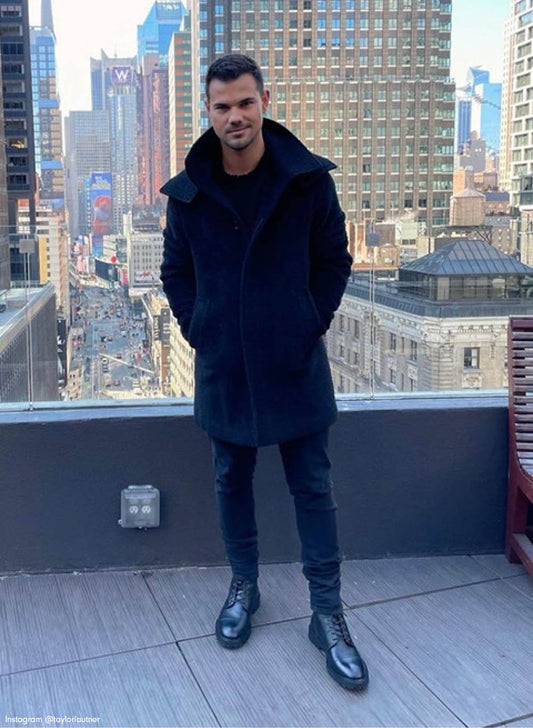 American actor Taylor Lautner is wearing the SENTALER Men Technical Bouclé Alpaca Double Collar Topcoat in Black on a rooftop in New York.