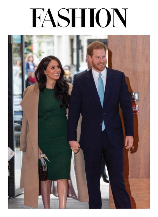 Image features the FASHION logo and an image of the Duchess of Cambridge, Meghan Markle wearing the Sentaler Long Wide Collar Wrap Coat featured in Baby Alpaca and available in Camel alongside Prince Harry.