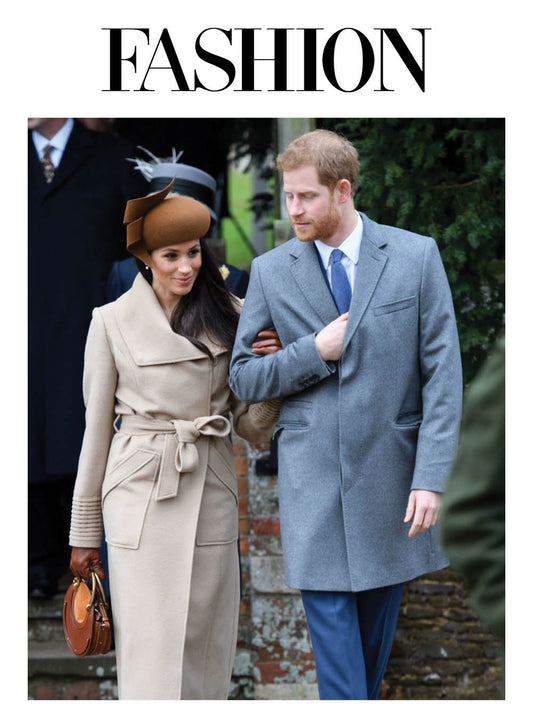 Image features the FASHION logo and an image of the Duchess of Cambridge, Meghan Markle wearing the Sentaler Long Wide Collar Wrap Coat featured in Baby Alpaca and available in Camel alongside Prince Harry.