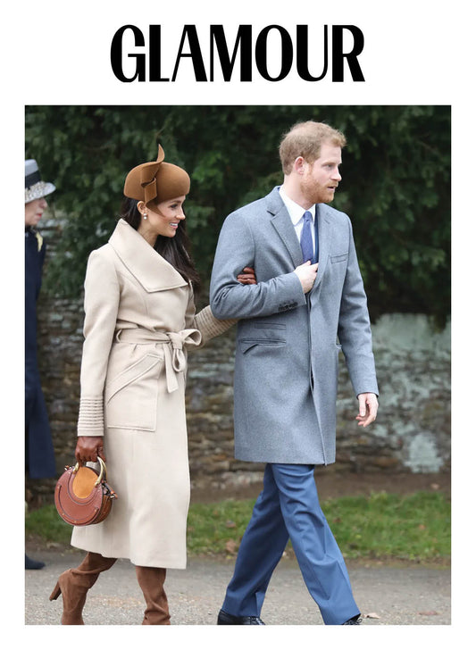 Image features the Glamour logo and an image of the Duchess of Cambridge, Meghan Markle wearing the Sentaler Long Wide Collar Wrap Coat featured in Baby Alpaca and available in Camel alongside Prince Harry.