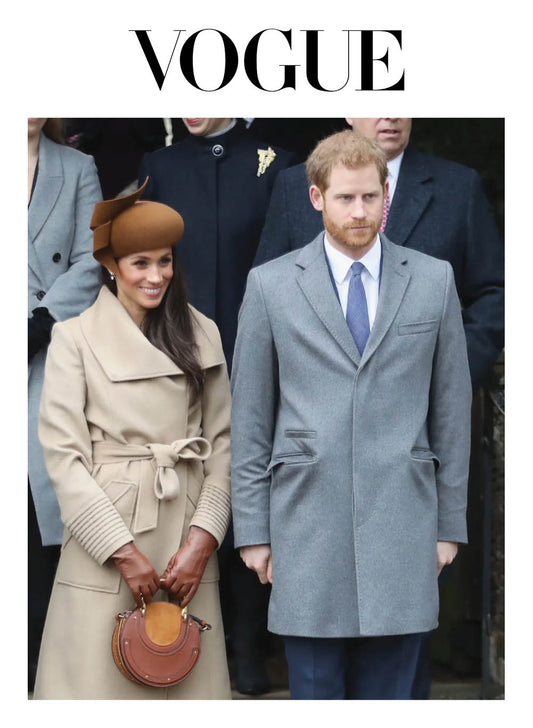 Image features the Vogue logo and an image of the Duchess of Cambridge, Meghan Markle wearing the Sentaler Long Wide Collar Wrap Coat featured in Baby Alpaca and available in Camel alongside Prince Harry.