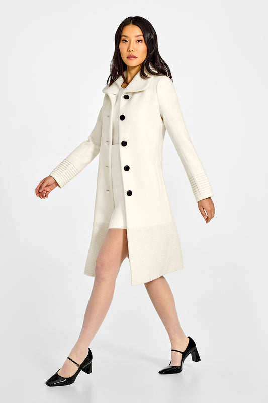 Sentaler A-line Ivory Coat with Bouclé Alpaca Collar and Trim in Baby Alpaca wool. Seen from side open on a female model.