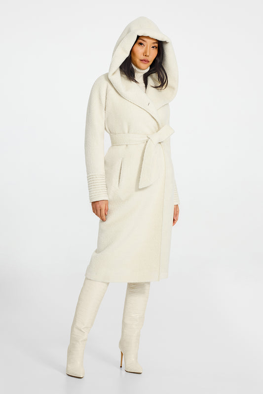 Sentaler Bouclé Alpaca Long Hooded Ivory Coat in Bouclé Alpaca wool. Seen from side belted with hood on female model.