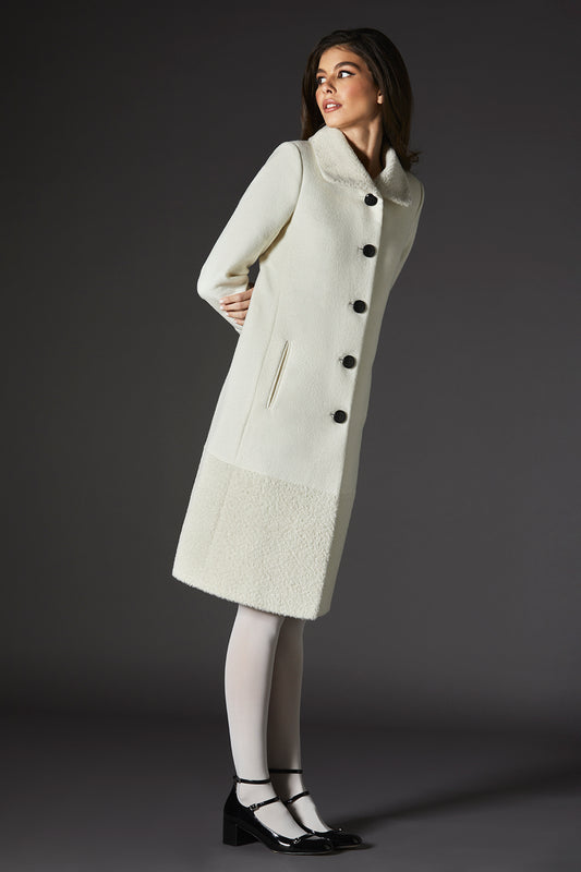 Sentaler Baby Alpaca A-line Ivory Coat with Bouclé Alpaca Collar and Trim in Baby Alpaca wool. Seen from side on female model.