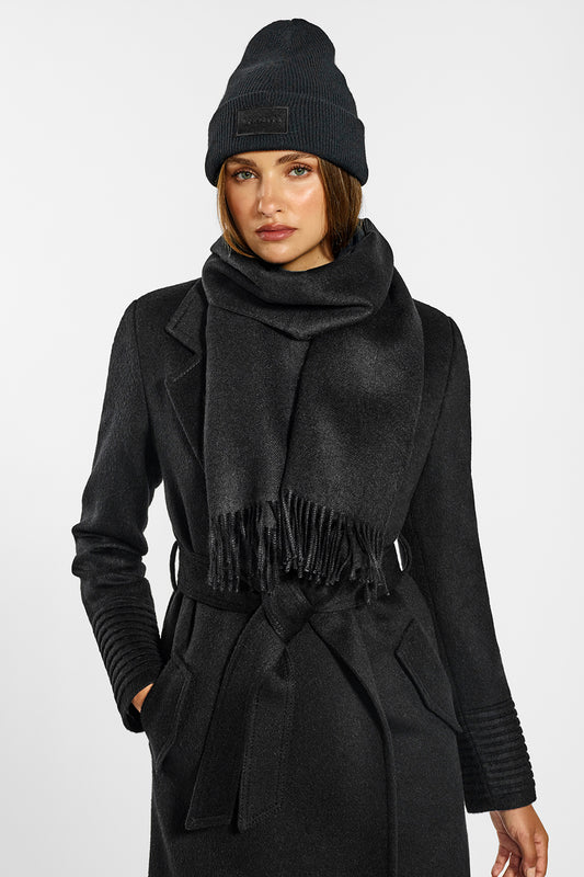 Sentaler Long Notched Collar Wrap Coat and Alpaca Beanie crafted in Baby Alpaca wool and in Black. Seen from front belted above the knees on female model.