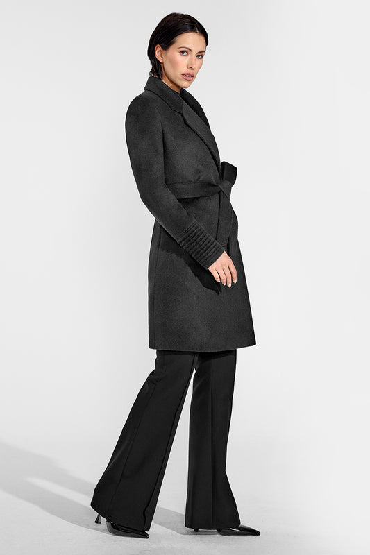 Sentaler Mid Length Notched Collar Wrap Coat featured in Baby Alpaca and available in Black. Seen from side on female model who is wearing the coat belted.