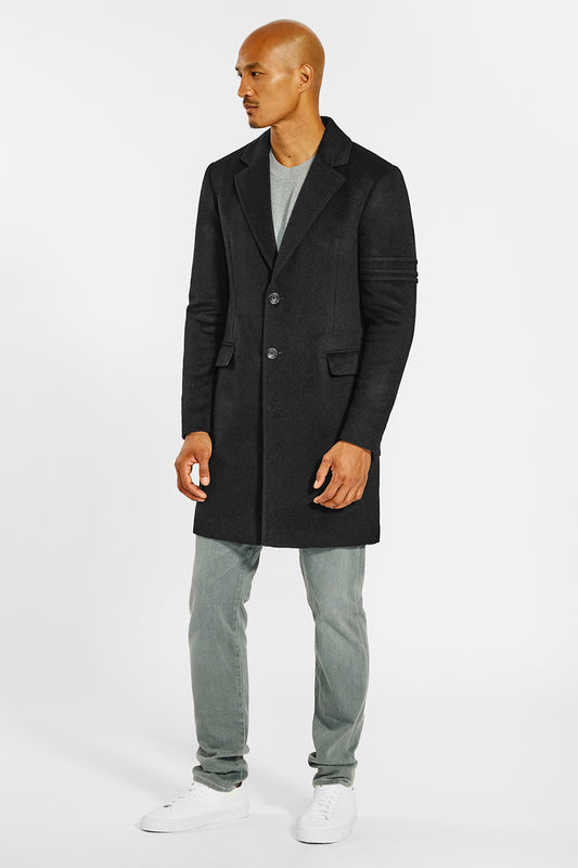 Sentaler Technical Baby Alpaca Notched Lapel Overcoat crafted in Technical Baby Alpaca and available in Black. Seen from side on male model.
