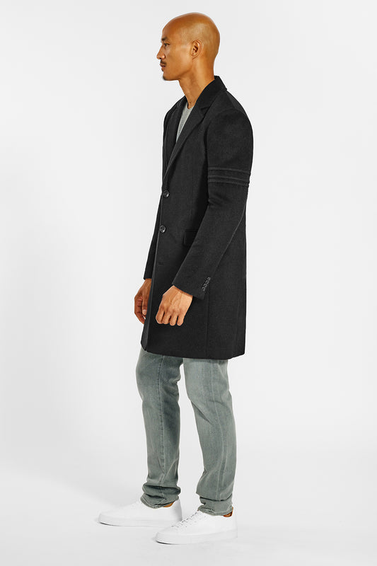 Sentaler Technical Baby Alpaca Notched Lapel Overcoat crafted in Technical Baby Alpaca and available in Black. Seen from side on male model.
