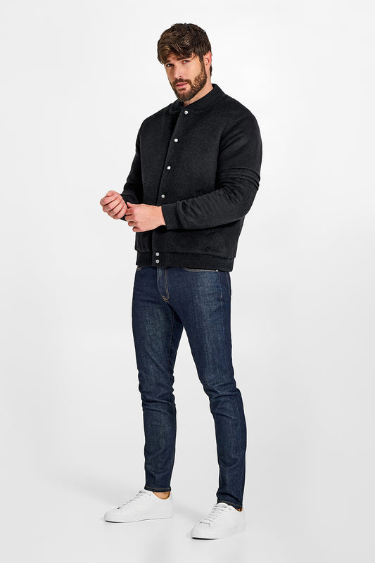 Sentaler Baby Alpaca Varsity Black Jacket in Technical Baby Alpaca wool. Seen from side on male model.