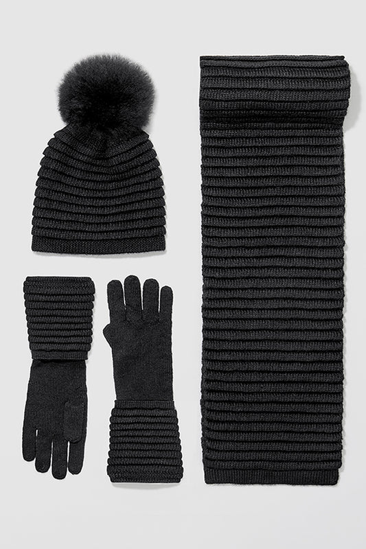 Sentaler Adult Ribbed Hat With Oversized Fur Pompon, Adult Ribbed Scarf and Adult Ribbed Gloves featured in Baby Alpaca and available in Black. Seen as off figures.
