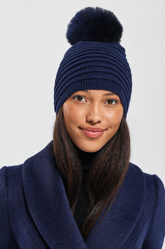 Sentaler Adult Ribbed Hat With Oversized Fur Pompon featured in Baby Alpaca and available in Navy. Seen from front close-up.