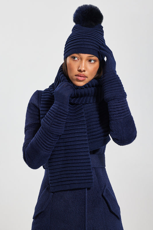 Sentaler Adult Ribbed Hat With Oversized Fur Pompon featured in Baby Alpaca and available in Navy. Seen with scarf and gloves 1.