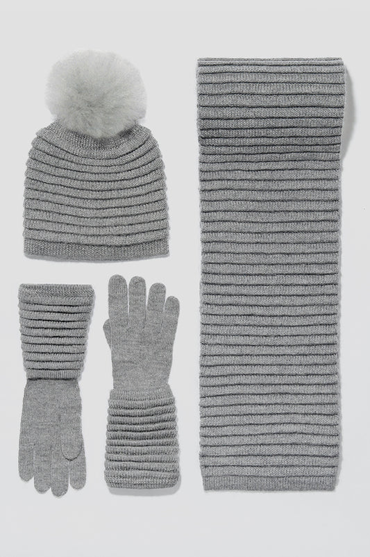 Sentaler Adult Ribbed Scarf, Ribbed Hat with Oversized Fur Pompon, Ribbed Gloves featured in Baby Alpaca and available in Grey. Seen as off figures.