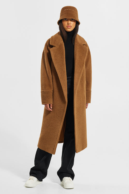 Sentaler Bouclé Alpaca Long Oversized Notched Collar Coat featured in Bouclé Alpaca and available in Caramel Café. Seen from side wearing Bouclé Alpaca Bucket hat.
