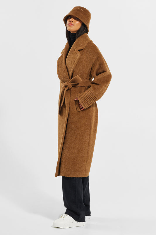 Sentaler Bouclé Alpaca Long Oversized Notched Collar Coat featured in Bouclé Alpaca and available in Caramel Café. Seen from side wearing Bouclé Alpaca Bucket hat.
