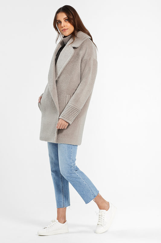 Sentaler Bouclé Alpaca Mid Length Oversized Notched Collar Coat featured in Bouclé Alpaca and available in Sand. Seen from side.
