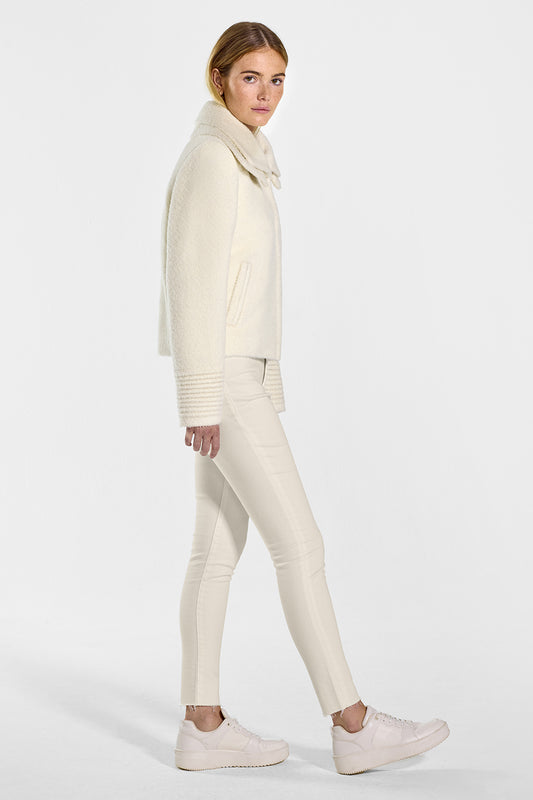 Sentaler Bouclé Alpaca Moto Jacket with Signature Double Collar featured in Bouclé Alpaca and available in Ivory. Seen from side on model.