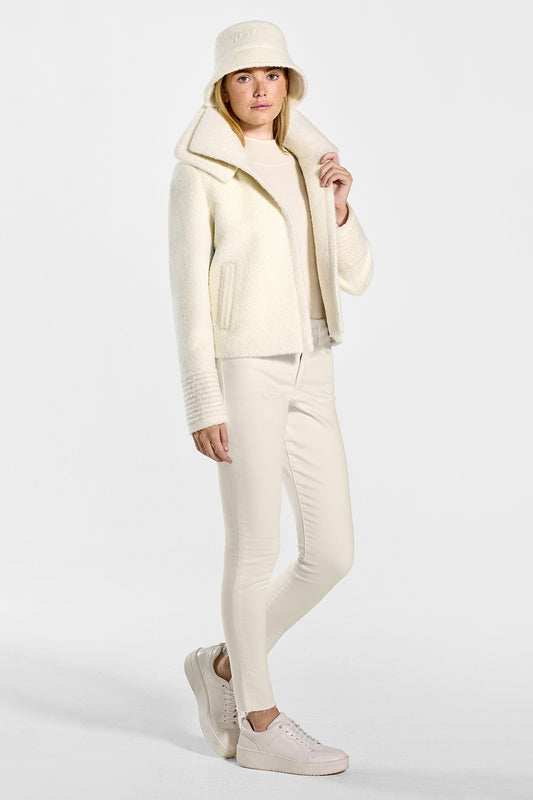 Sentaler Bouclé Alpaca Moto Jacket with Signature Double Collar and Bouclé Alpaca Bucket Hat featured in Bouclé Alpaca and available in Ivory. Seen from side open on model.