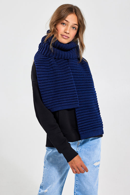 Sentaler Kids (6-14 Years) Ribbed Scarf featured in Baby Alpaca and available in Navy. Seen from front above the knee.