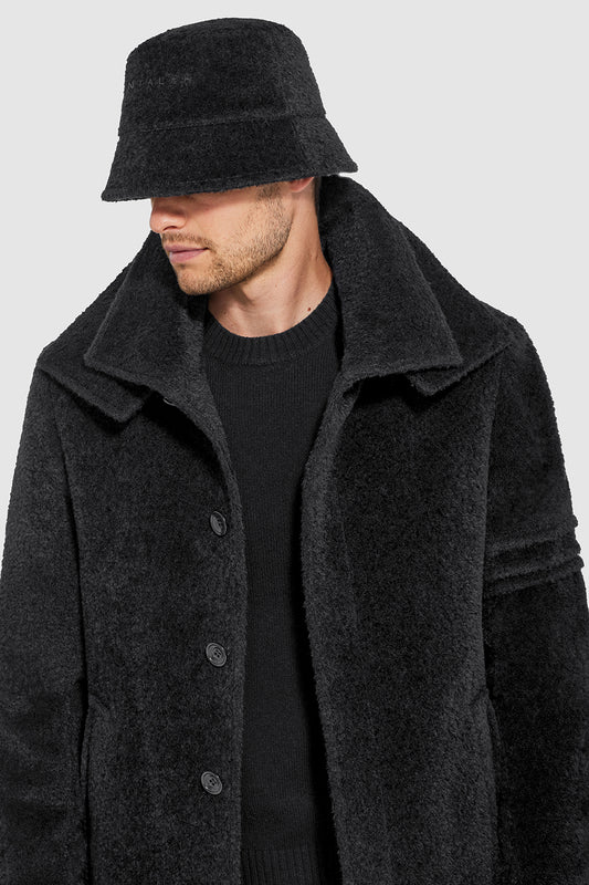Sentaler Mens Bouclé Alpaca Bucket Hat featured in Bouclé Alpaca and available in Black. Seen from side close up on model.
